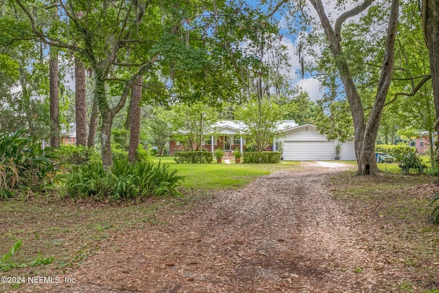 single story home with a garage, driveway, and a front lawn