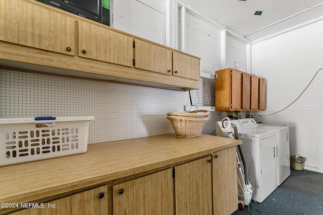 clothes washing area featuring cabinet space and independent washer and dryer