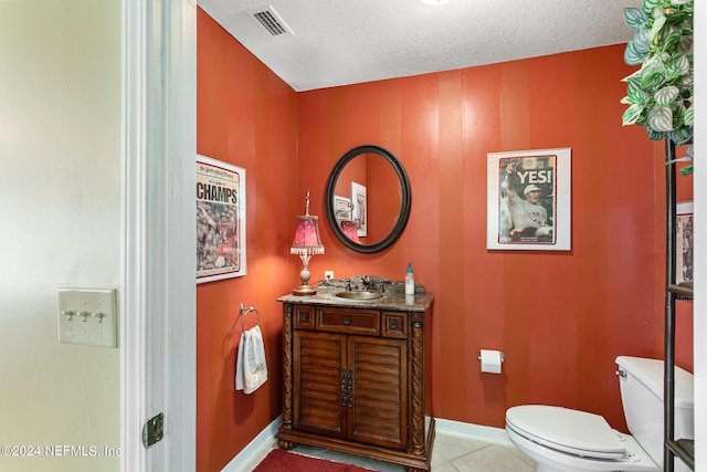 bathroom with visible vents, toilet, a textured ceiling, tile patterned flooring, and baseboards