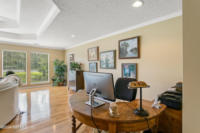 office area with crown molding, a textured ceiling, and light wood-style floors