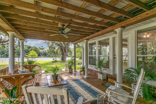 view of patio / terrace featuring ceiling fan and a water view