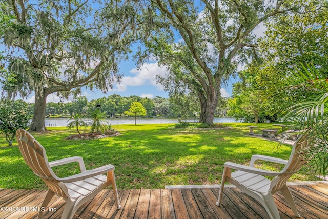 exterior space with a water view and a lawn