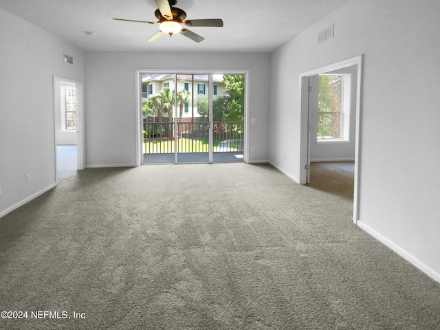 carpeted empty room featuring ceiling fan