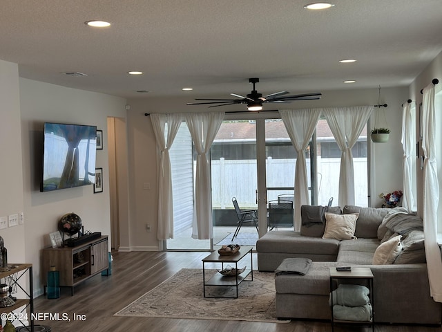 living room featuring hardwood / wood-style floors, a textured ceiling, french doors, and ceiling fan