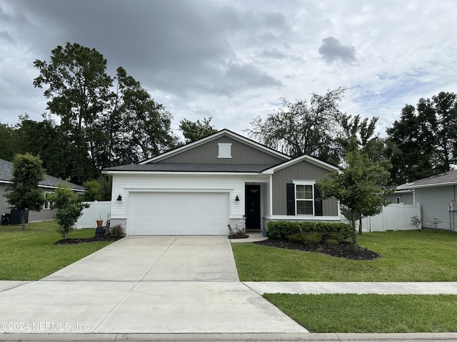 view of front of house featuring a garage and a front lawn