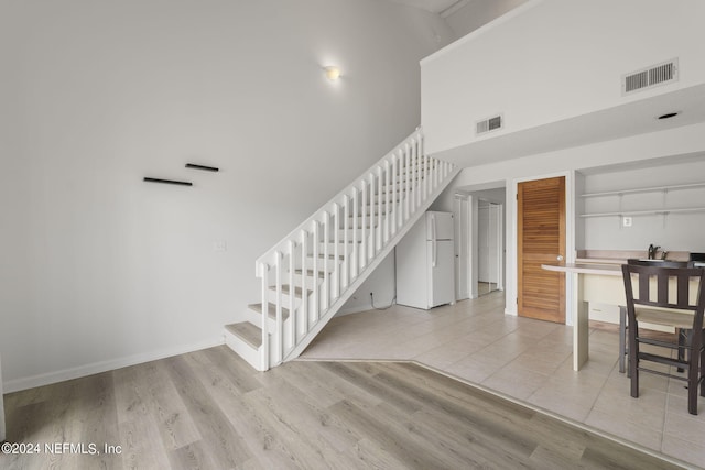 stairway featuring hardwood / wood-style flooring and sink