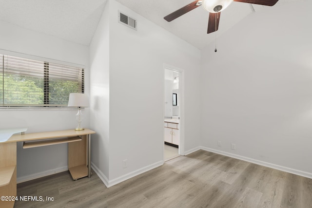 unfurnished bedroom with vaulted ceiling, ceiling fan, light hardwood / wood-style flooring, and ensuite bath