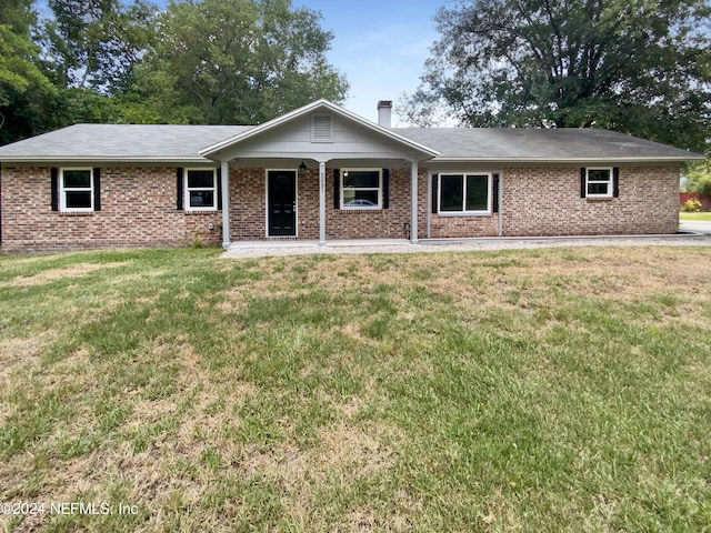 ranch-style home with a front lawn