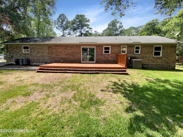 back of house featuring a wooden deck, a lawn, and central AC