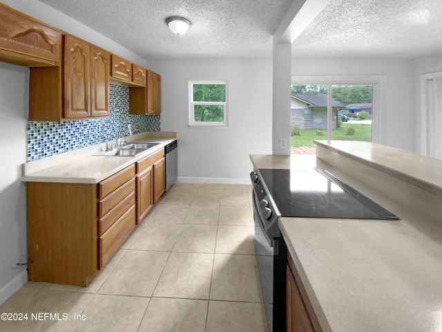 kitchen featuring light tile patterned floors, stainless steel dishwasher, decorative backsplash, sink, and black range with electric cooktop