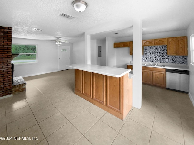 kitchen with backsplash, stainless steel dishwasher, a textured ceiling, and electric panel