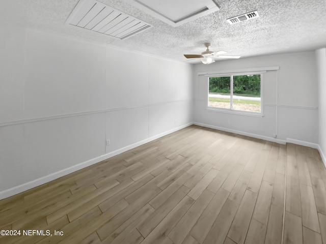 empty room with ceiling fan and light wood-type flooring