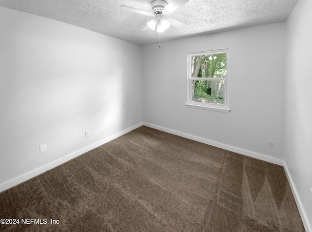 carpeted spare room with a textured ceiling and ceiling fan