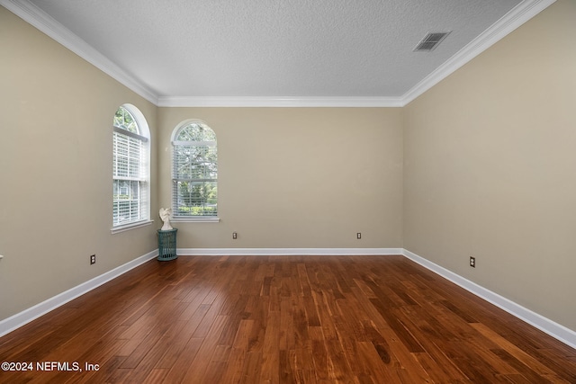 unfurnished room with a textured ceiling, crown molding, and dark hardwood / wood-style floors