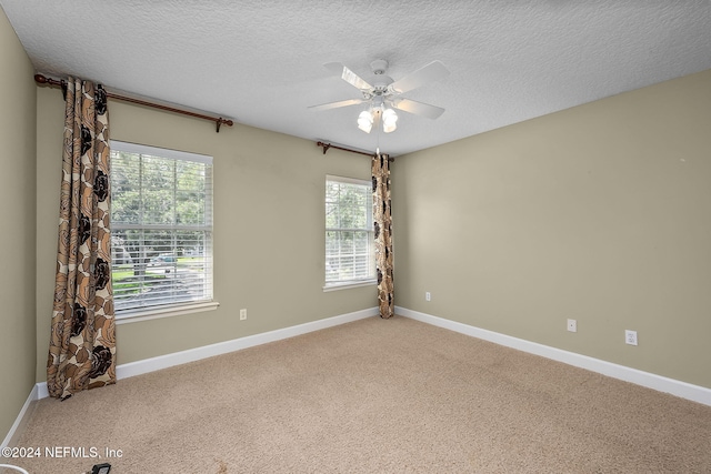 spare room with ceiling fan, carpet floors, and a textured ceiling