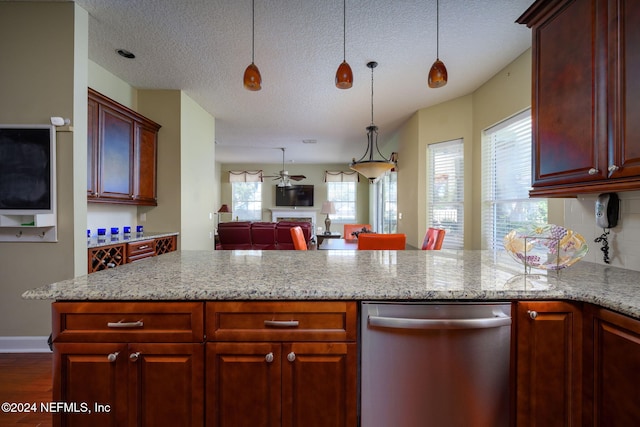 kitchen with stainless steel dishwasher, plenty of natural light, and light stone countertops