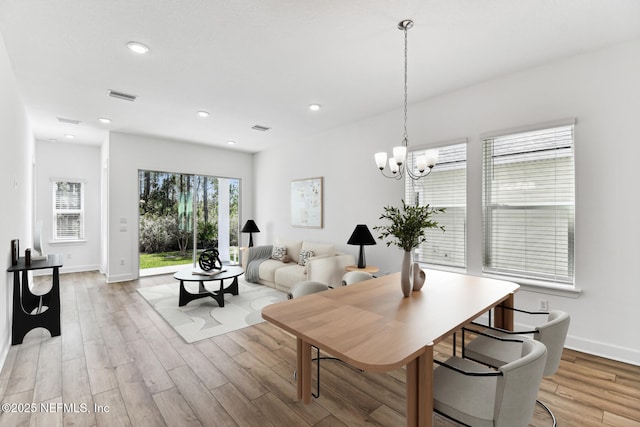 dining area featuring light wood finished floors, baseboards, visible vents, an inviting chandelier, and recessed lighting