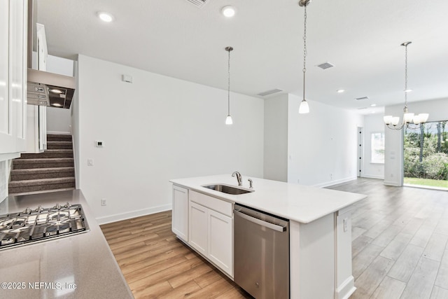 kitchen with light countertops, visible vents, appliances with stainless steel finishes, light wood-style floors, and a sink