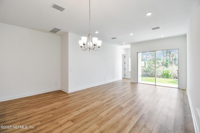 interior space featuring a notable chandelier, visible vents, and light wood-style floors