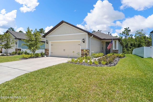 view of front of house with a front yard and a garage