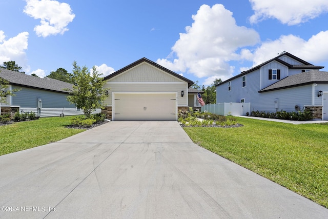 view of front of property with a garage and a front lawn