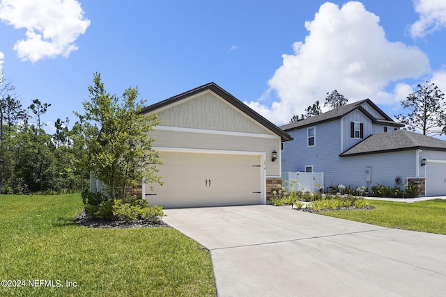 view of front of home featuring a garage and a front lawn