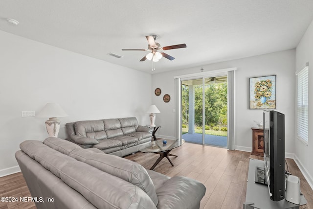 living room featuring light hardwood / wood-style floors and ceiling fan