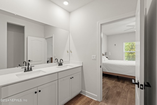 bathroom with ceiling fan, hardwood / wood-style floors, and vanity