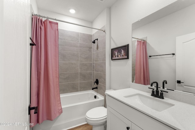 full bathroom with hardwood / wood-style floors, vanity, toilet, and shower / bath combo with shower curtain