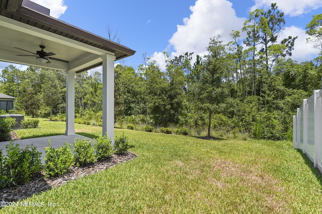 view of yard with ceiling fan and a patio area