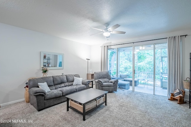 carpeted living room featuring a textured ceiling and ceiling fan