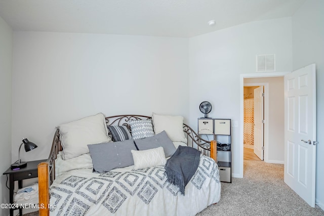 bedroom featuring light colored carpet