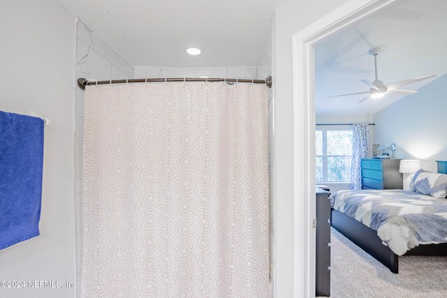 bathroom with walk in shower and ceiling fan