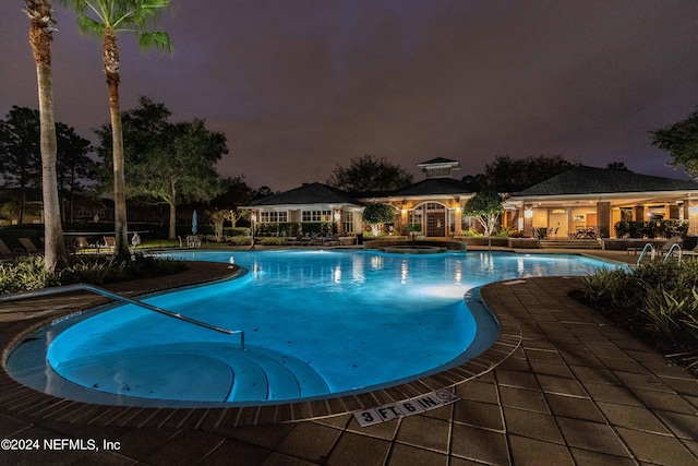 view of pool with a hot tub and a patio area