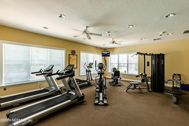 exercise room featuring ceiling fan and a textured ceiling