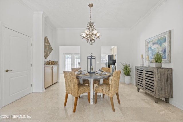 dining area with french doors, crown molding, and a notable chandelier