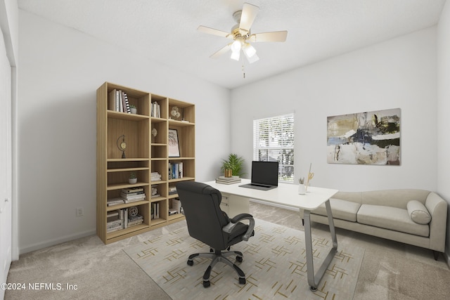 carpeted office space featuring ceiling fan