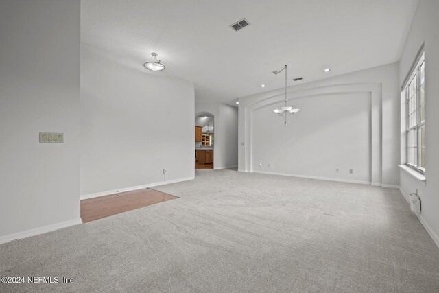 interior space featuring carpet flooring and vaulted ceiling