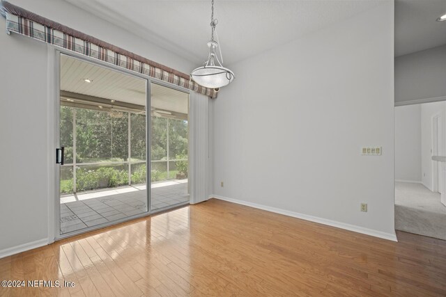 spare room with hardwood / wood-style floors and a healthy amount of sunlight