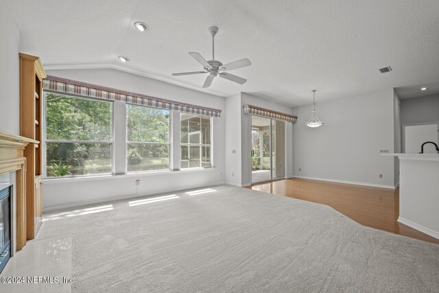 living room with hardwood / wood-style floors, ceiling fan, and vaulted ceiling