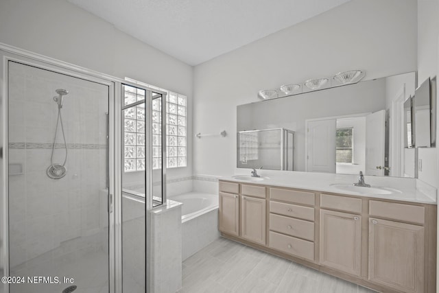 bathroom with independent shower and bath, tile patterned floors, and dual bowl vanity