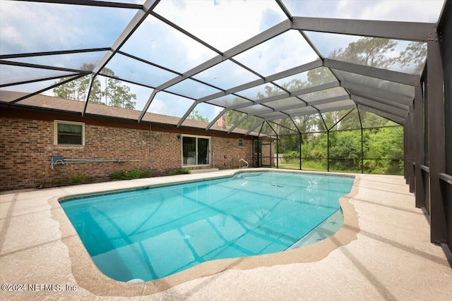 view of swimming pool featuring a lanai