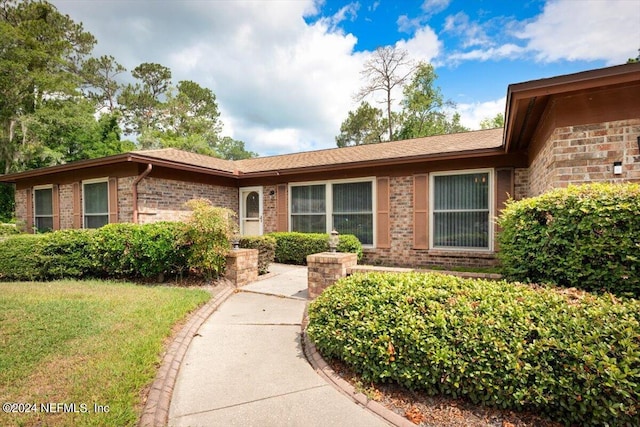 ranch-style house with a front yard