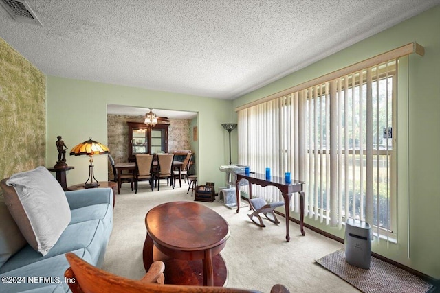 carpeted living room with a healthy amount of sunlight and a textured ceiling