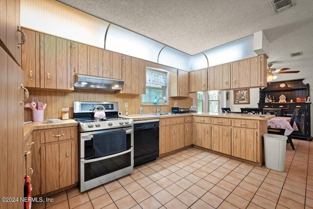 kitchen with light tile flooring, range with two ovens, ceiling fan, black dishwasher, and a textured ceiling