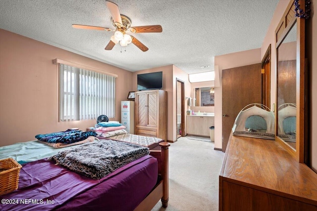 bedroom featuring a textured ceiling, carpet flooring, connected bathroom, and ceiling fan