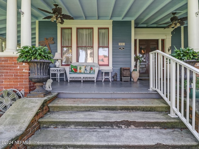 doorway to property featuring a porch and ceiling fan