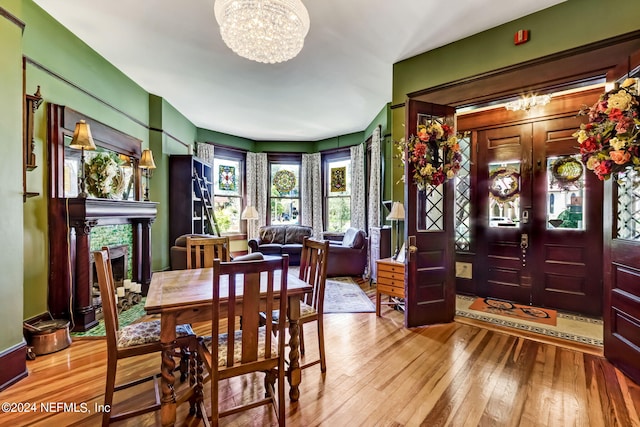 dining space with a chandelier and light hardwood / wood-style flooring