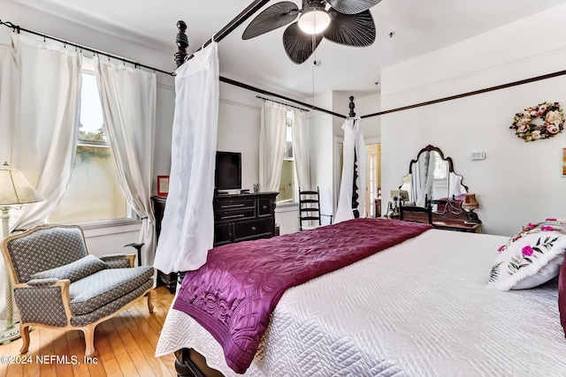 bedroom with ceiling fan and hardwood / wood-style flooring