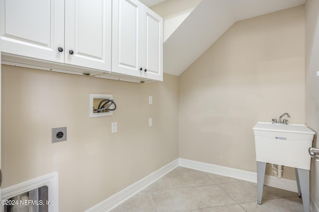 laundry room with cabinet space, baseboards, hookup for an electric dryer, washer hookup, and light tile patterned flooring